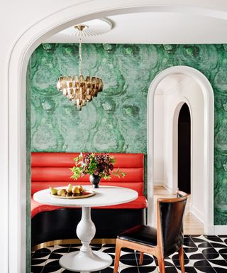Red sofa, black and white tiled floor, green wallpaper