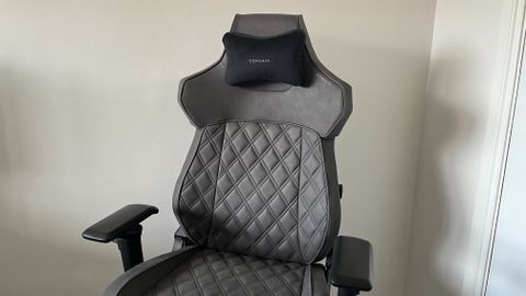 A Corsair Gaming Chair in a plain room.