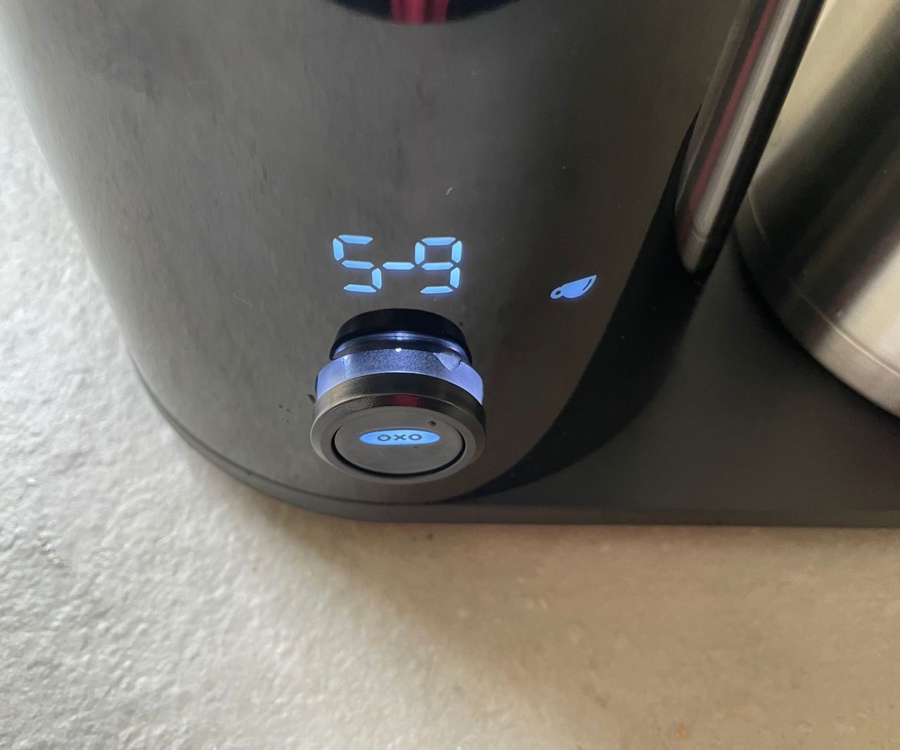 a close up of the blue LED control panel on the OXO 9 cup coffee maker