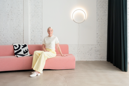 Sabine Marcelis on pink sofa.