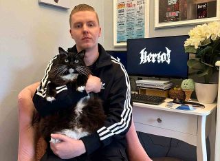 Heriot’s Julian Cage with his pet cat Kylo