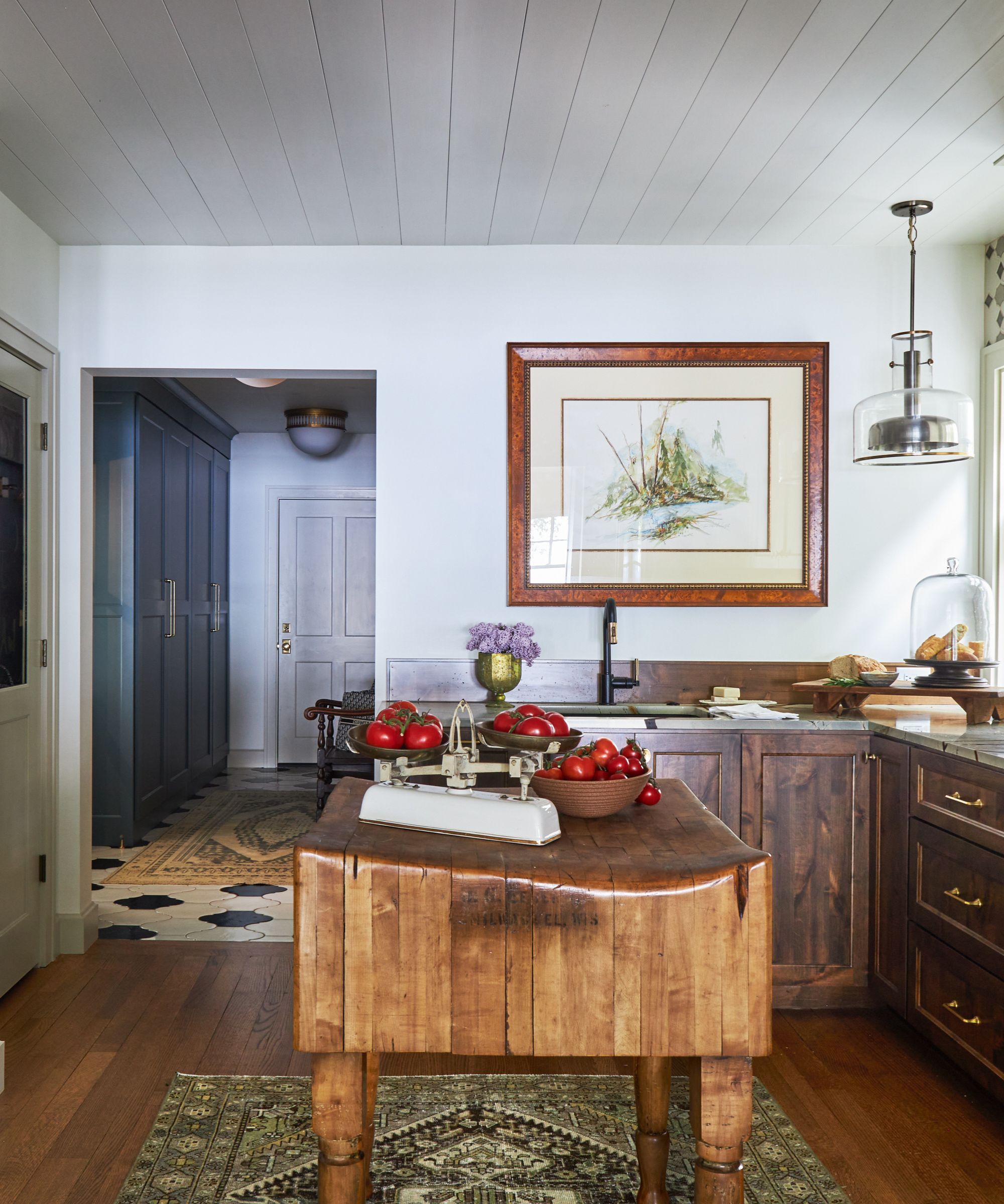 A cozy, inviting kitchen with a freestanding wooden kitchen island