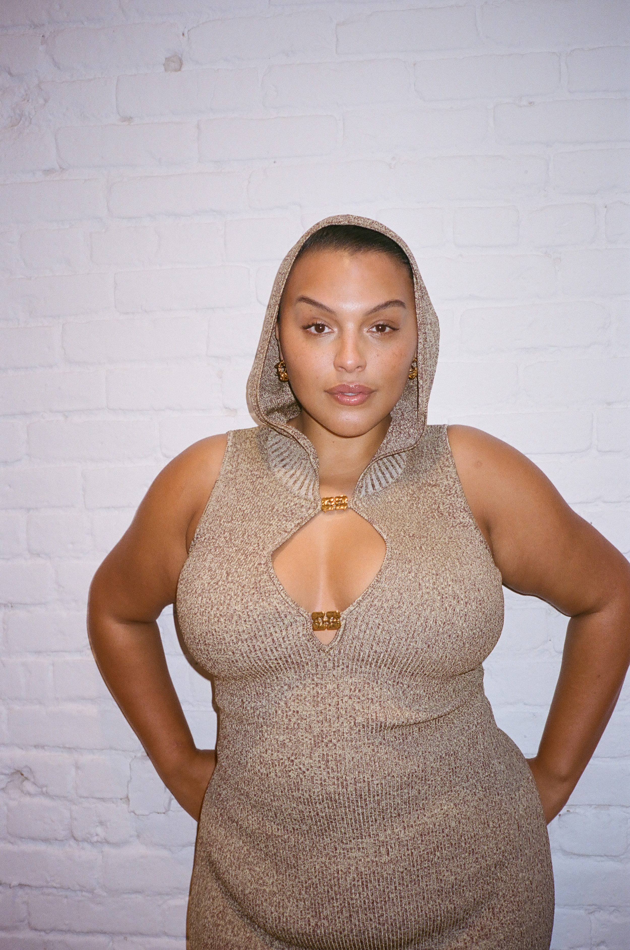 portrait photo of Paloma Elsesser wearing a hooded sweaterdress
