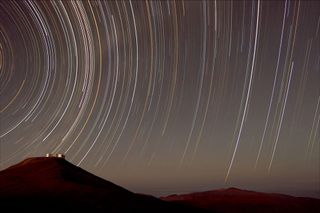 Southern sky stars appear to track above the Paranal Observatory in Chile.