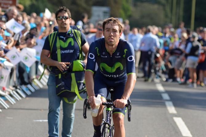 A satisfied Alex Dowsett heads for the race leader's podium