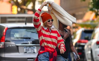 gigi hadid wearing a rugby sweater and a beanie