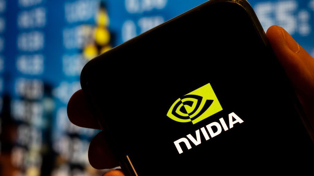 A hand holding a phone bearing the Nvidia logo