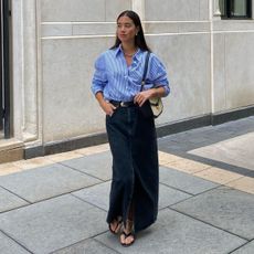 @sasha.mei wears a blue stripe shirt and denim skirt