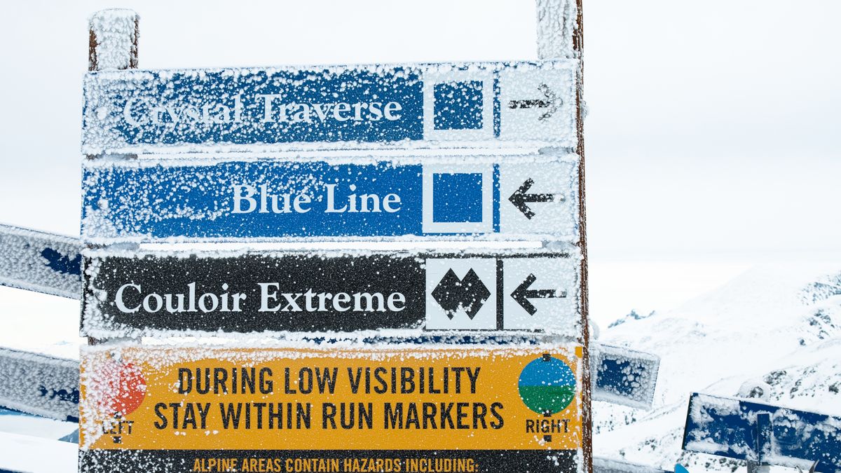 Snow covered signs at a ski resort