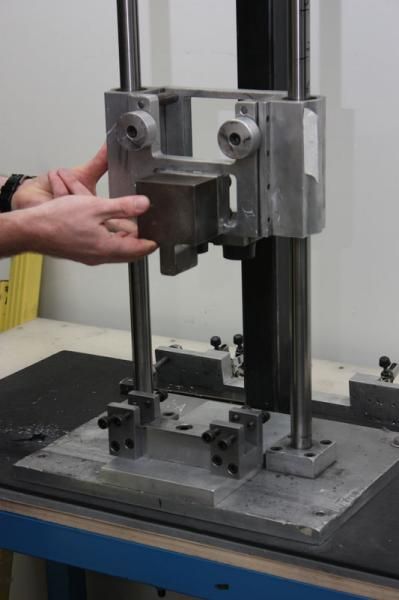 Rim sections are tested for impact toughness on this brutal-looking jig.