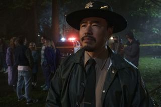 Randall Park as cynical sheriff Denis Lim.
