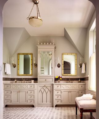 white bathroom with twin sinks and ornately detailed vanity units