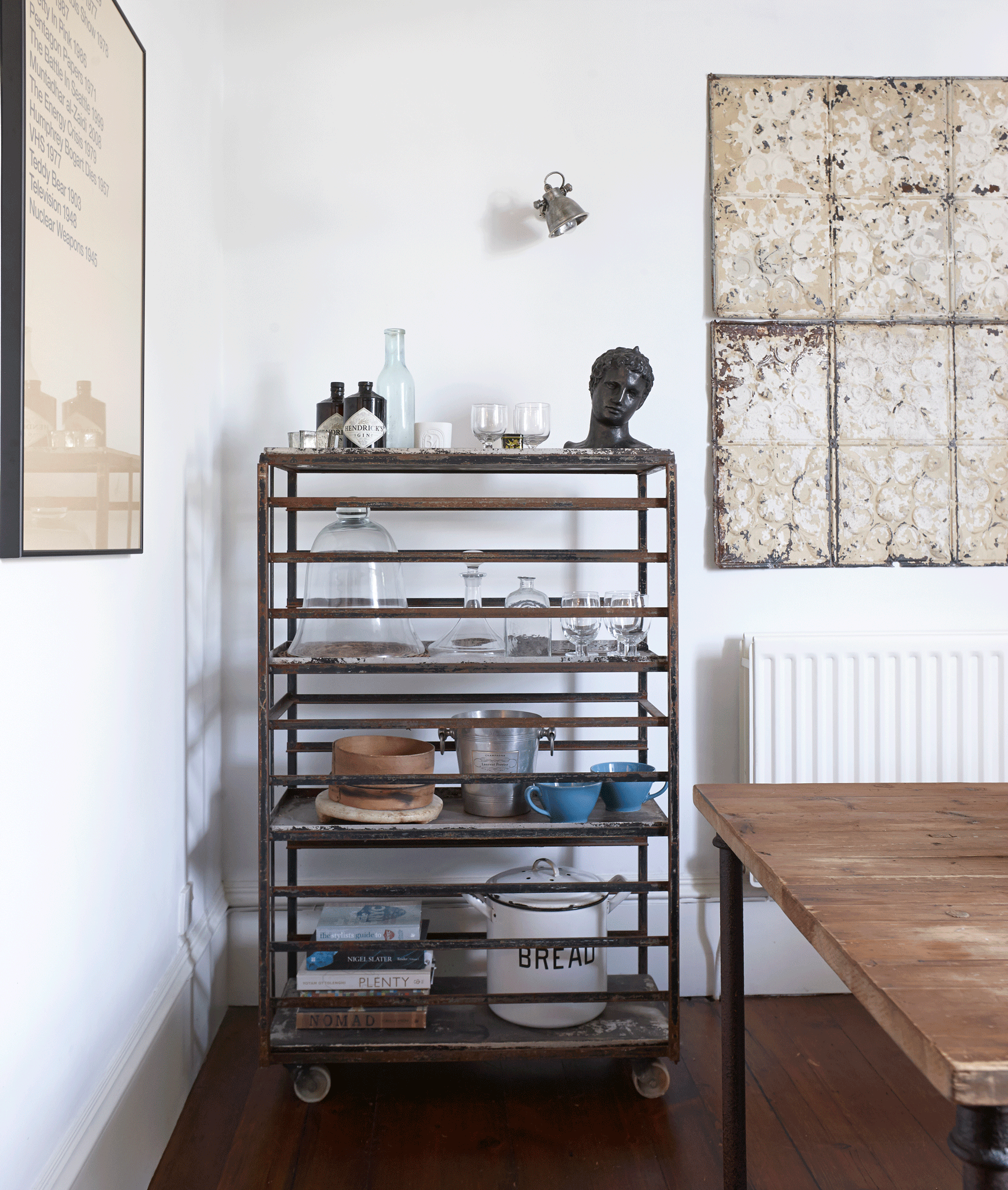 A metal storage trolley in the corner of a white kitchen