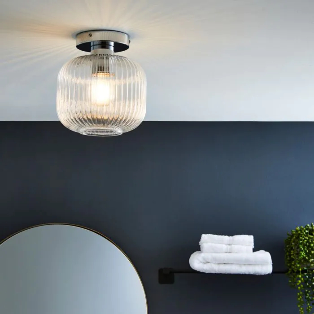 glass and chrome ceiling light in bathroom