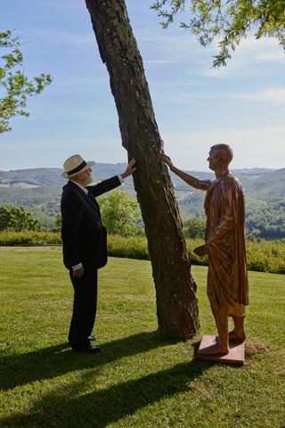 Italian artist Michelangelo Pistoletto is pictured with one of his four bronze works in Loving the World, now on view at Castello di Casole hotel, Tuscany for Mitico