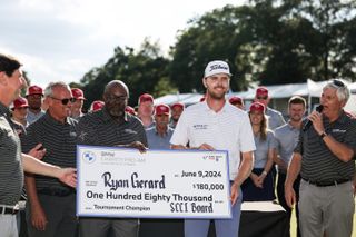 Ryan Gerard holds a cheque