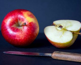 red cut apple with a knife
