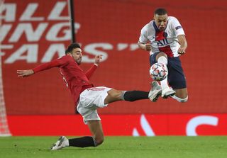 Kylian Mbappe, right, takes on Manchester United's Bruno Fernandes