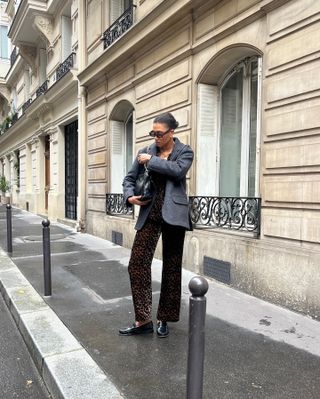 Woman in leopard pants and blazer.