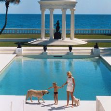 American writer C. Z. Guest and her son Alexander Michael Douglas Dudley Guest in front of their Grecian temple pool on the ocean-front estate, Villa Artemis, Palm Beach