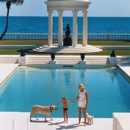 American writer C. Z. Guest and her son Alexander Michael Douglas Dudley Guest in front of their Grecian temple pool on the ocean-front estate, Villa Artemis, Palm Beach