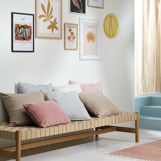guest room daybed ideas, daybed with gallery wall behind, cushions on top
