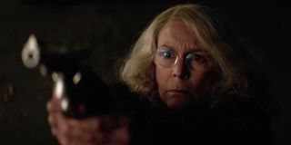 Jamie Lee Curtis as Laurie Strode holding a gun in Halloween 2018