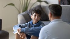 Teenage boy listens to father attentively