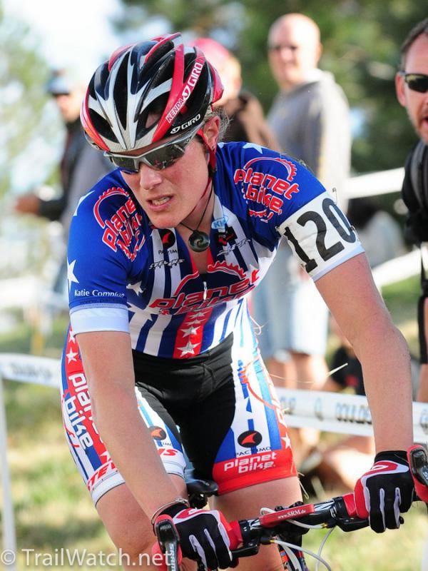 Katie Compton (Planet Bike) rides to the pits in obvious pain.