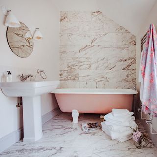 bathroom with wash basin and bathtub with white towels