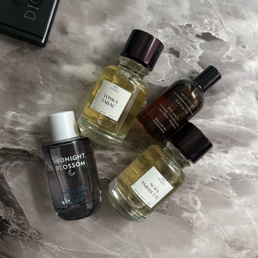 Four M&amp;S perfumes on a marble table