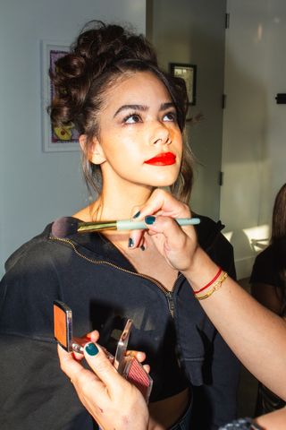 Antonia Gentry getting her makeup done before the tory burch show