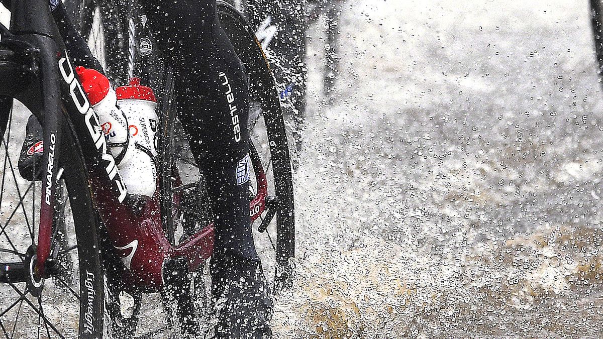 A bicycle riding through a deep puddle