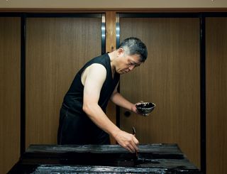 Masayoshi Nishiguchi working on Max Lamb's 'Urushi' table