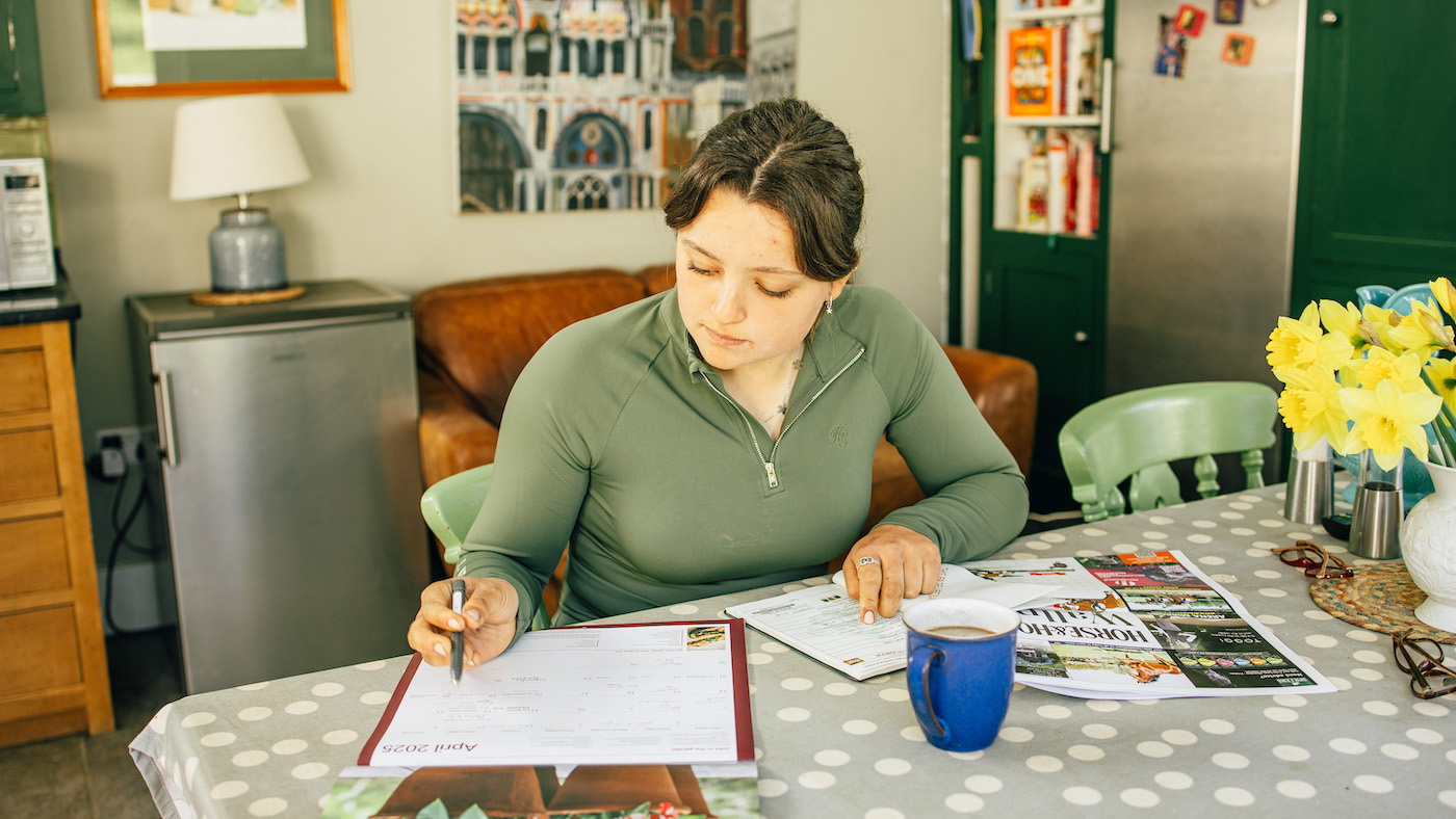 Lady sitting at table planning with cup of coffee