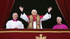 Pope Benedict XVI waves from a balcony after he was elected by the conclave of cardinals on 19 April 2005