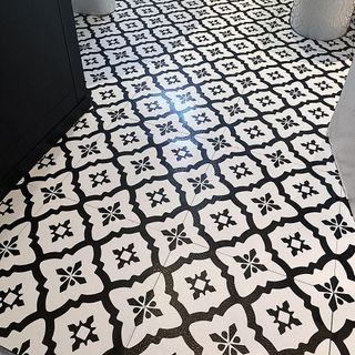 bathroom with black and white patterned tiles