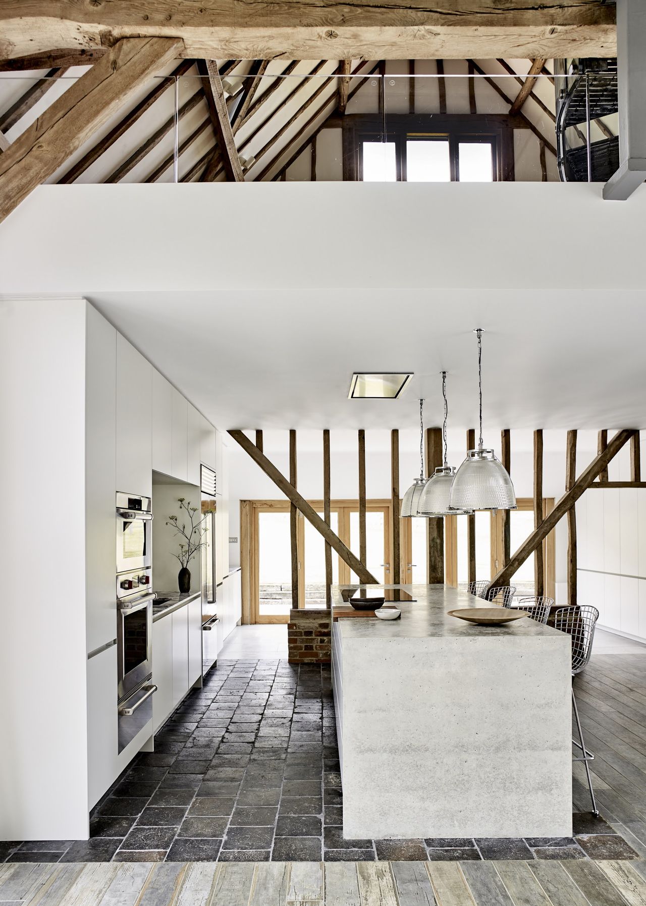 kitchen floor tile ideas with dark black tiles zoning an open plan kitchen in a barn