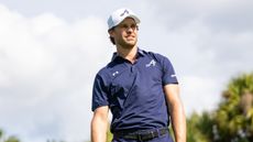 Thomas Detry wearing a blue 4Aces GC polo and white cap