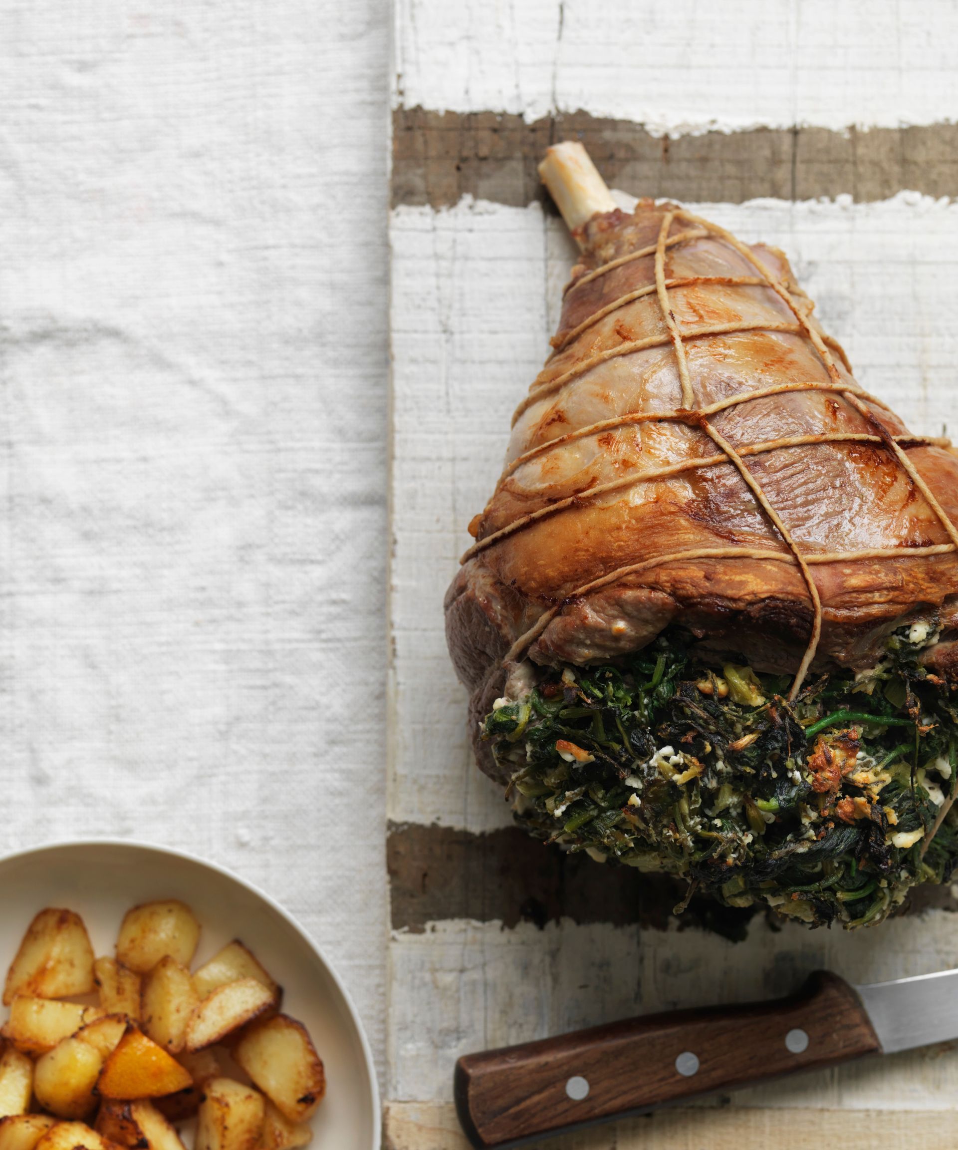 Overhead shot of lamb leg recipe stuffed with horta and feta
