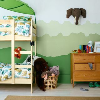 room with toy basket wooden cot and drawer