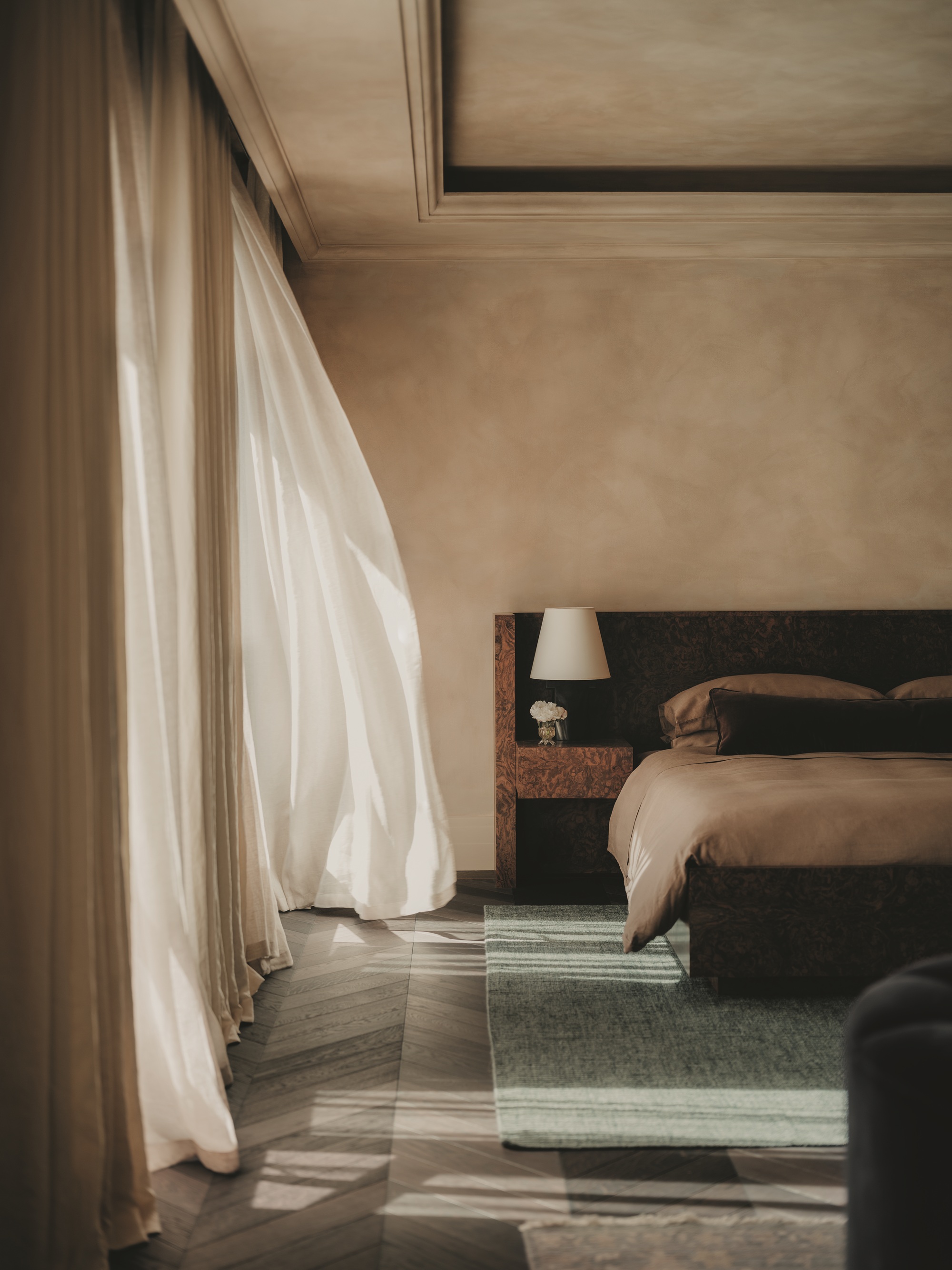 a limewash bedroom with a wood oversized headboard