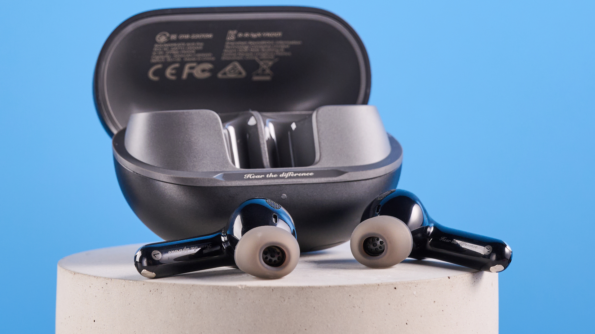 the soundpeats air5 pro earbuds in black and bronze with a black charging case and ear tips