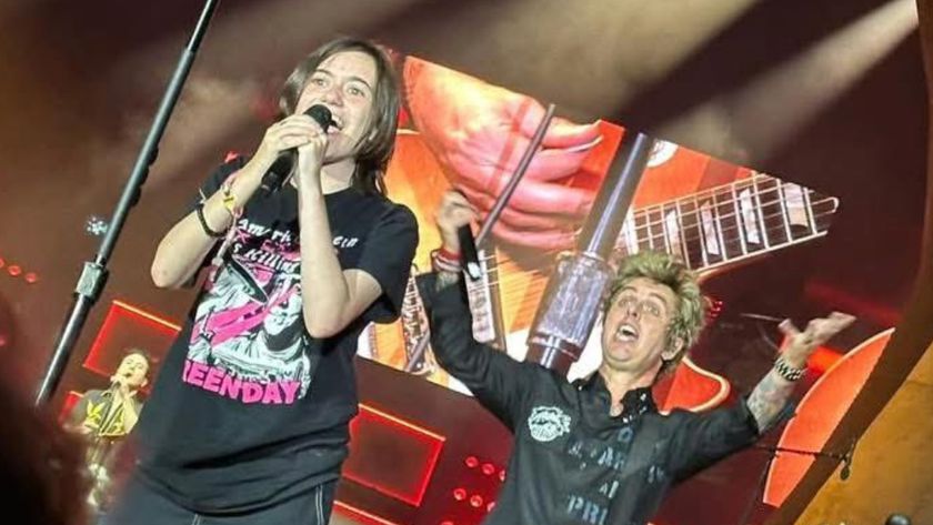 A young fan performs with Green Day