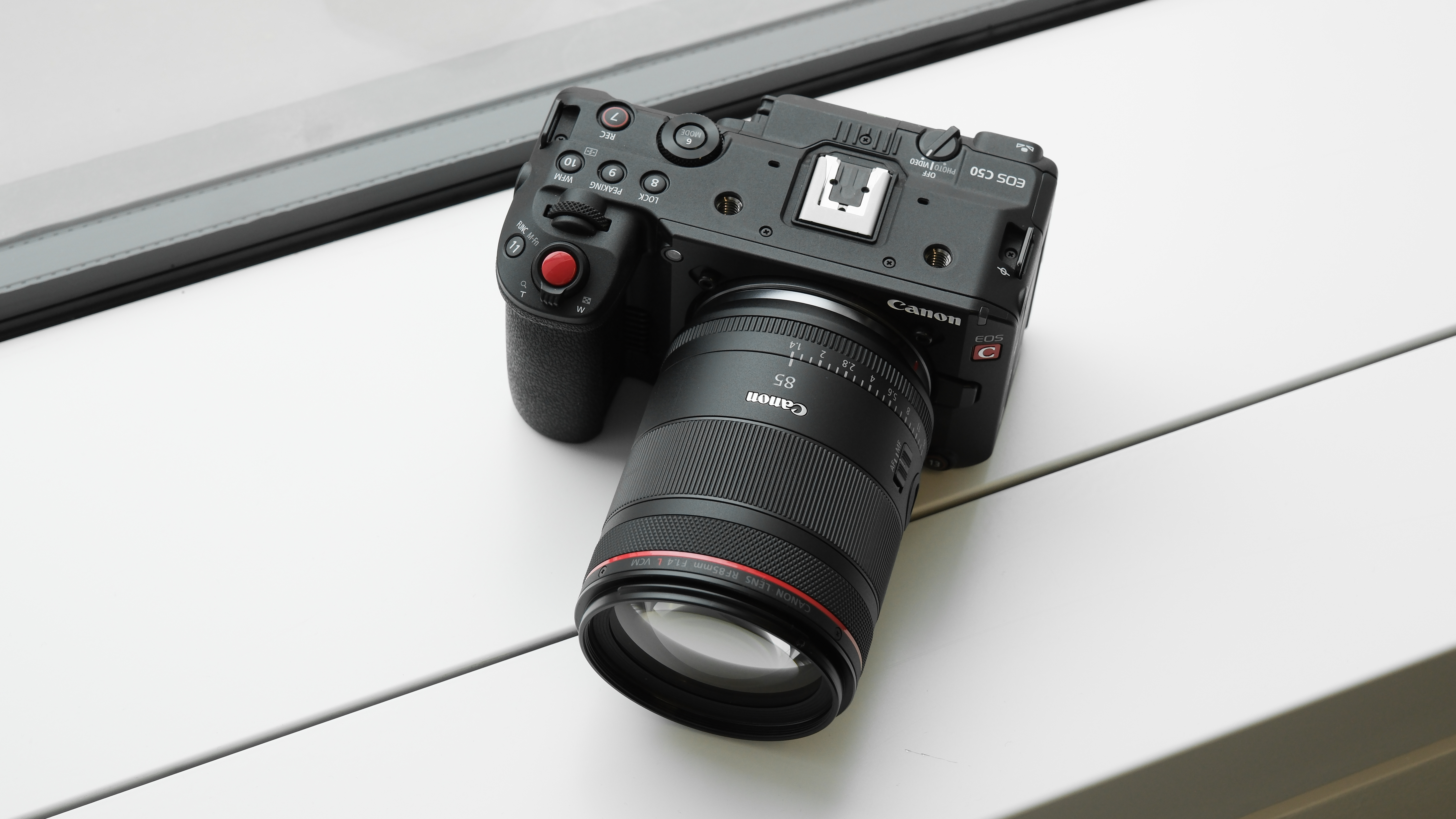 Canon EOS C50 with Canon RF 85mm f/1.4L VCM on a white background