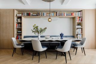 an apartment with a large dining table and banquette seating