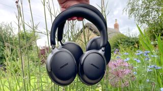 Bose QC Ultra and Sonos Ace in reviewer's garden