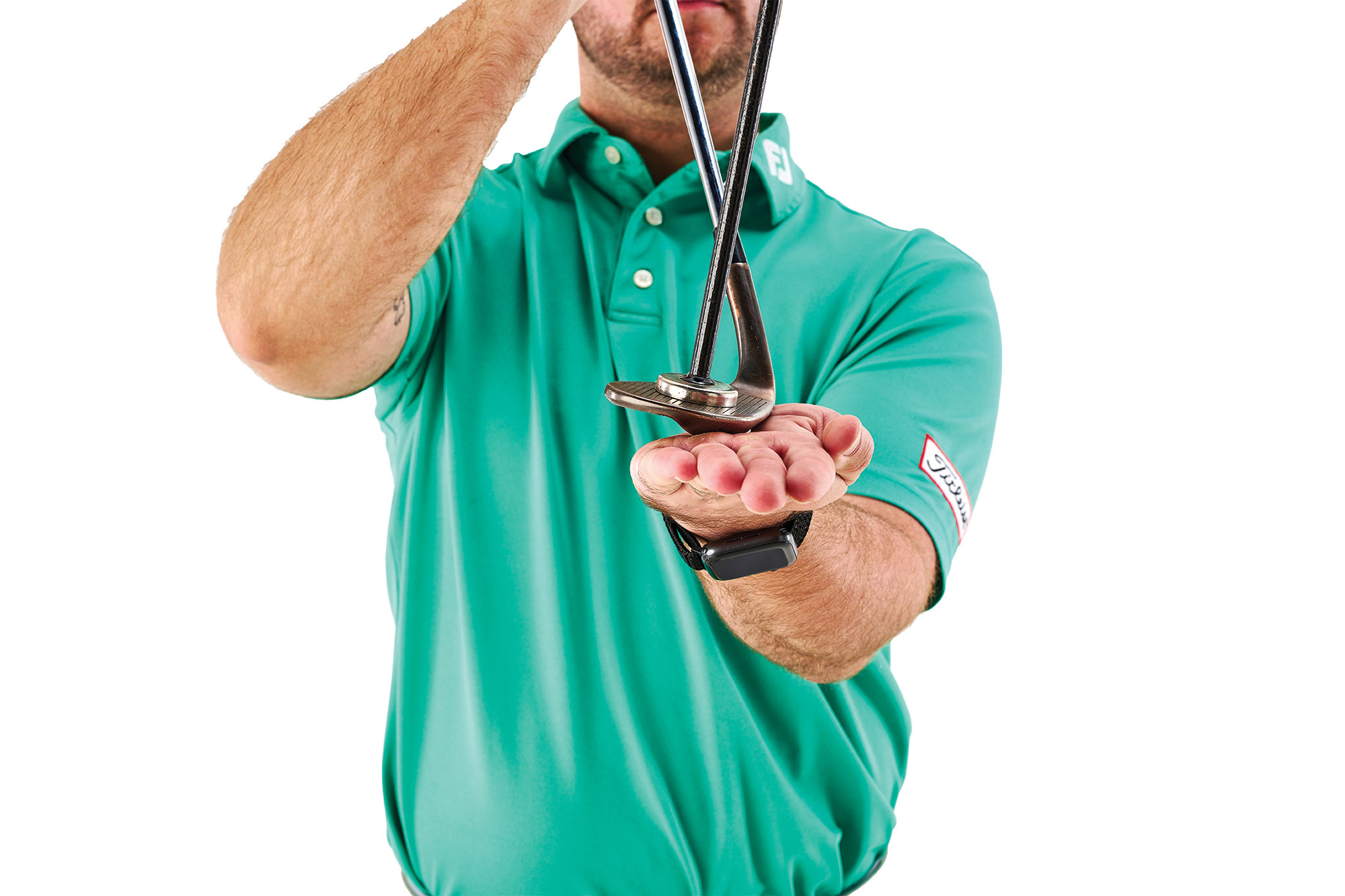 Joshua Mayo demonstrating loft with a wedge, using a metal rod stuck to the clubface to visually represent loft on the club