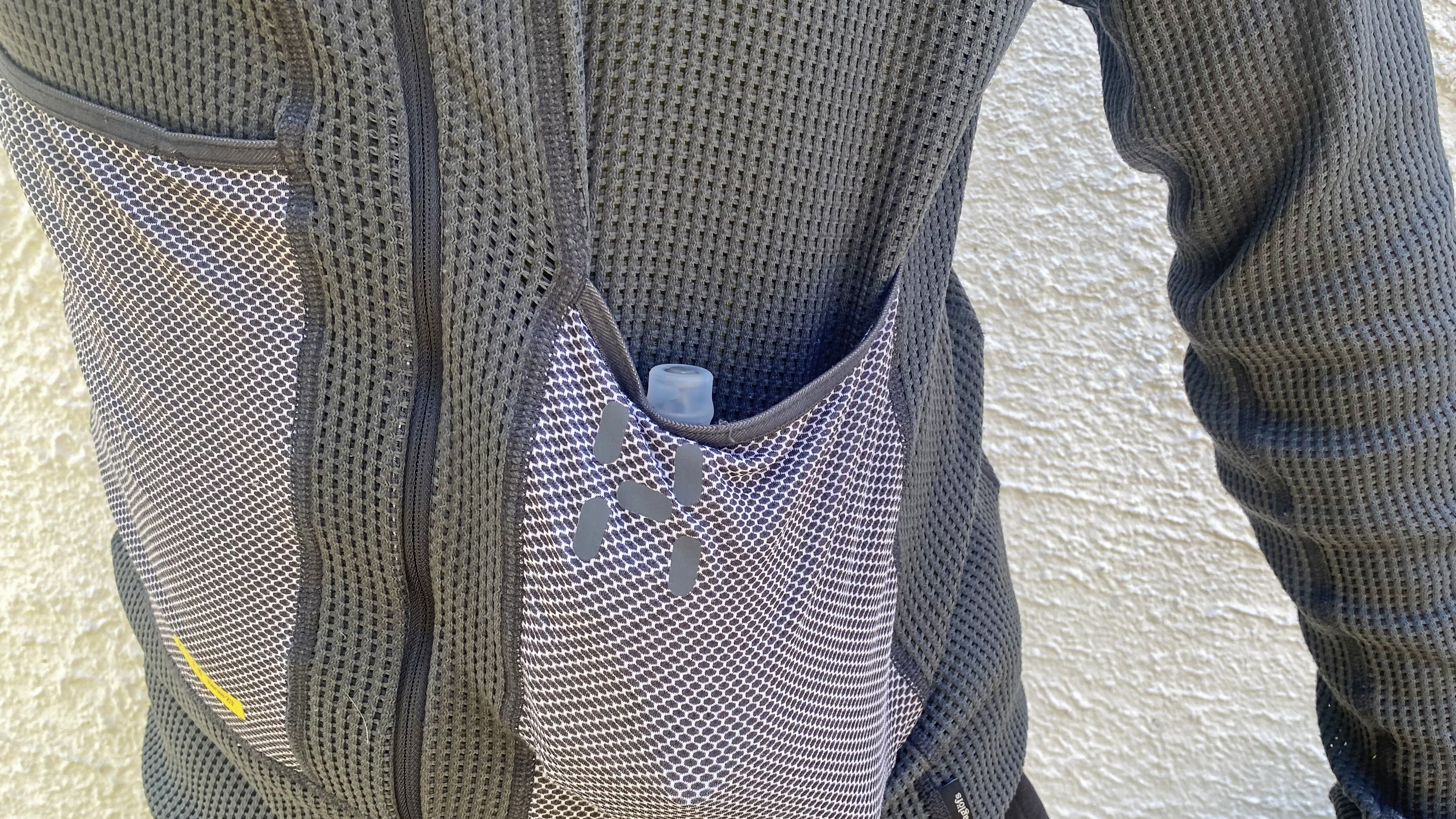 The Haglöfs L.I.M ZT II Air Midlayer with a water flask in the pouch