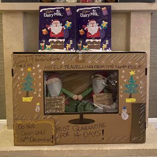 room with shelves purple cadbury box and santa in large box
